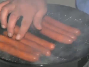 cooking hot dogs on a grill